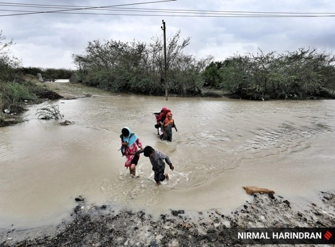 પાણીમાંથી પસાર થતા લોકો.(Express photo Nirmal Harindran)